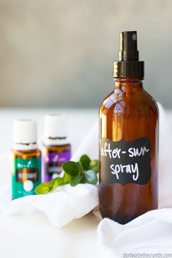 A glass bottle mister that says After-Sun Spray. There is a bottle of peppermint essentiol oil and lavendar essential oil.