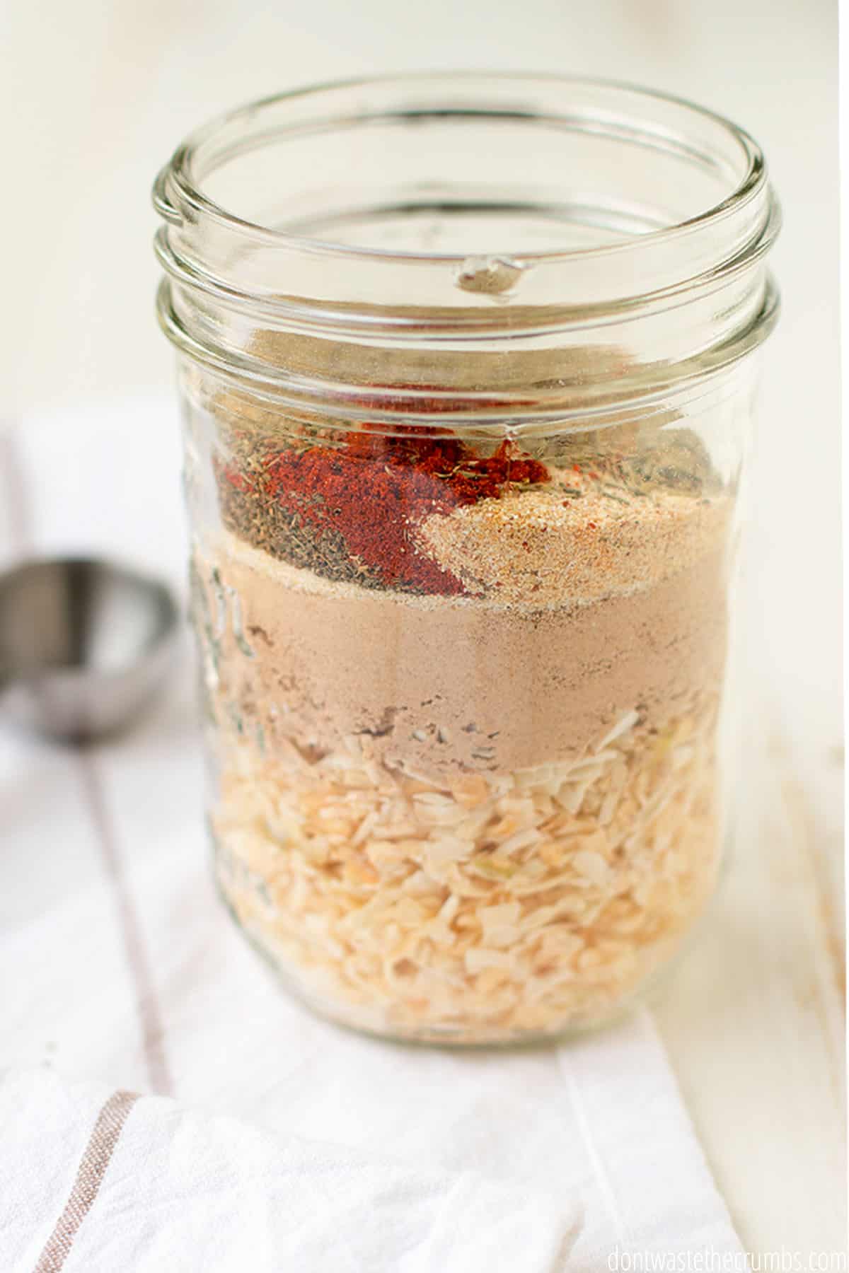 Glass jar with ingredients for dry onion soup mix.