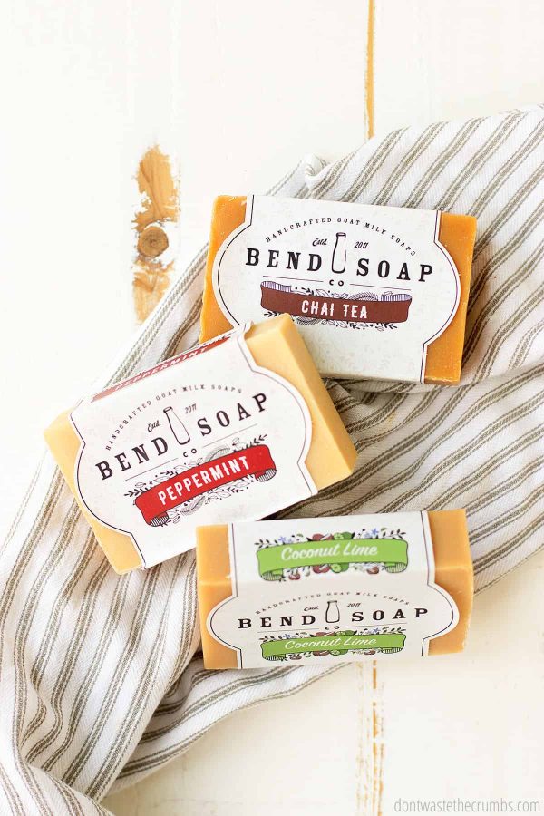 Goat milk soap benefits your skin. Bend Soap is the company that I always choose. Three bars from the company are laid out on a cloth.