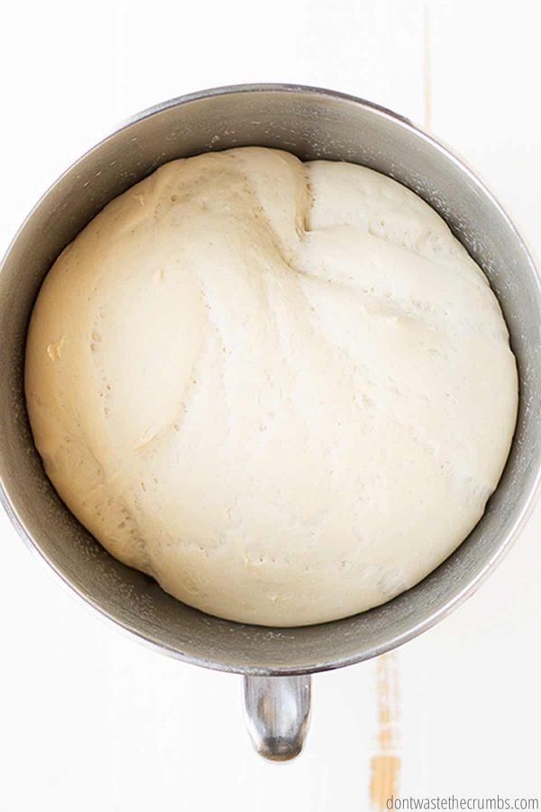 Pictured is pizza dough in a bowl.