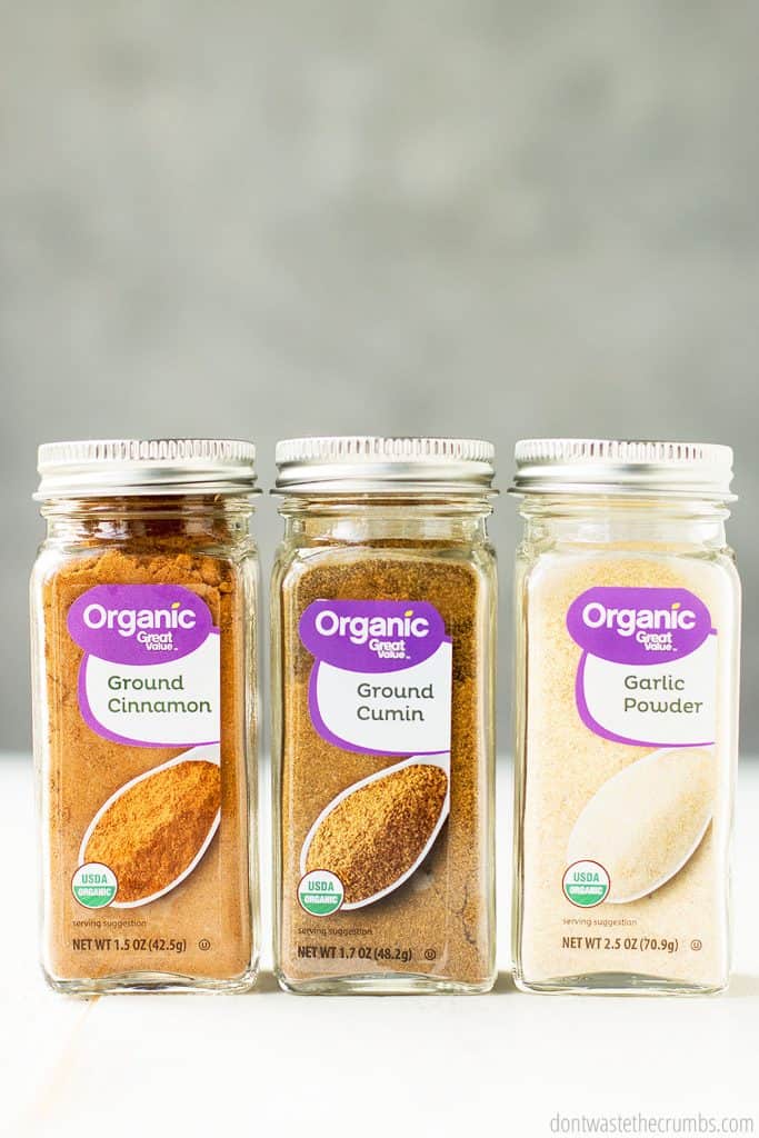 Three bottles of organic spices, ground cinnamon, ground cumin and garlic powder. Since organic spices are not contaminated with fumigants or additives, we prefer to cook with organic spices.