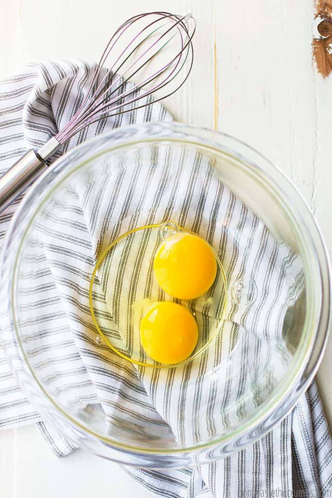 Two raw eggs in a bowl.