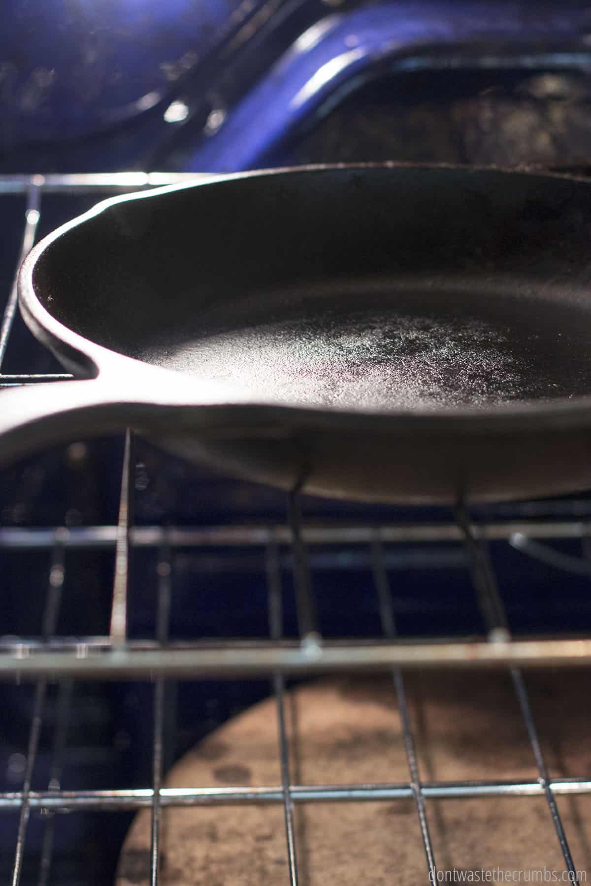 The baking step of seasoning cast iron: An oiled cast iron being baked in the oven so that the oil deeply penetrates the cast iron, creating a natural non-stick surface.