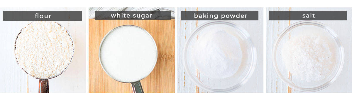 A collage of cake mix ingredients. From left, a measuring cup of flour, a measuring cup of sugar, a small glass dish of baking powder, and a small glass dish of salt