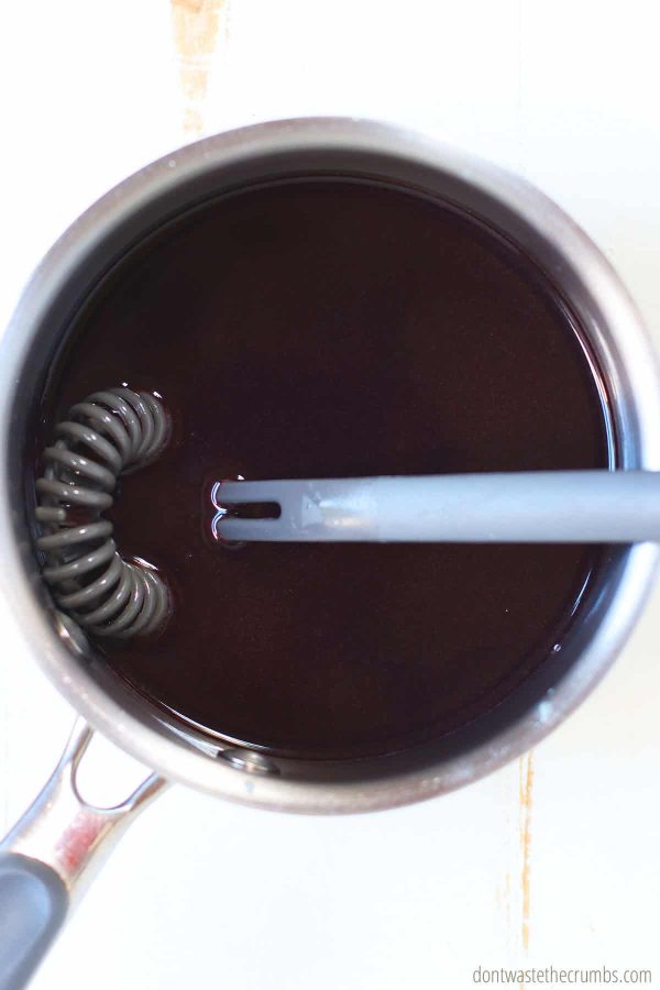 juice and gelatin heating in a small pot with a wisk