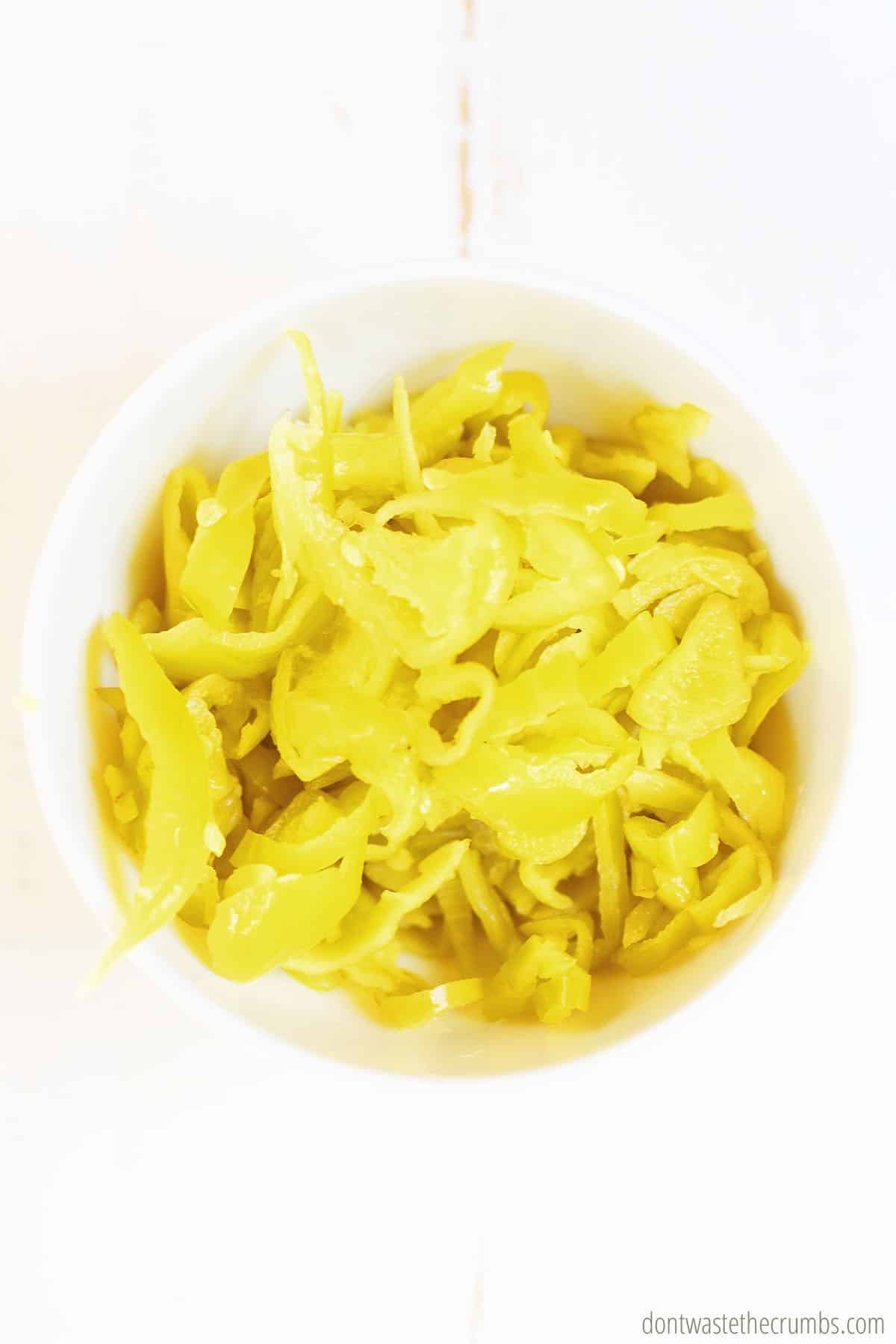 A bowl of sliced pepperoncini, which is the tangy ingredient in Mississippi Chicken. 