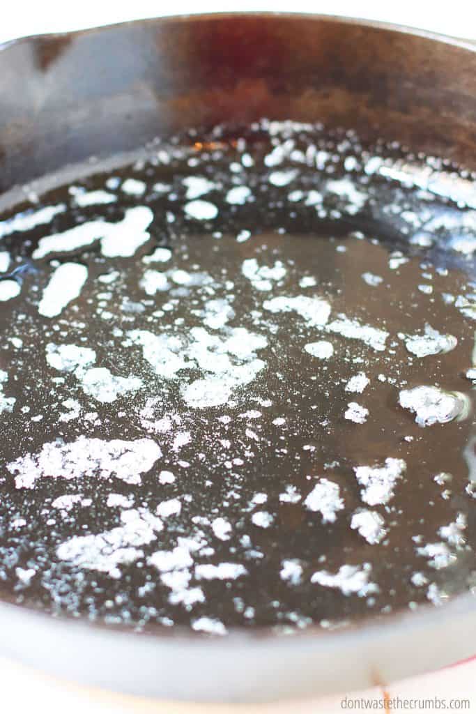 Butter melts inside the cast iron skillet; ready to make cast iron skillet cornbread