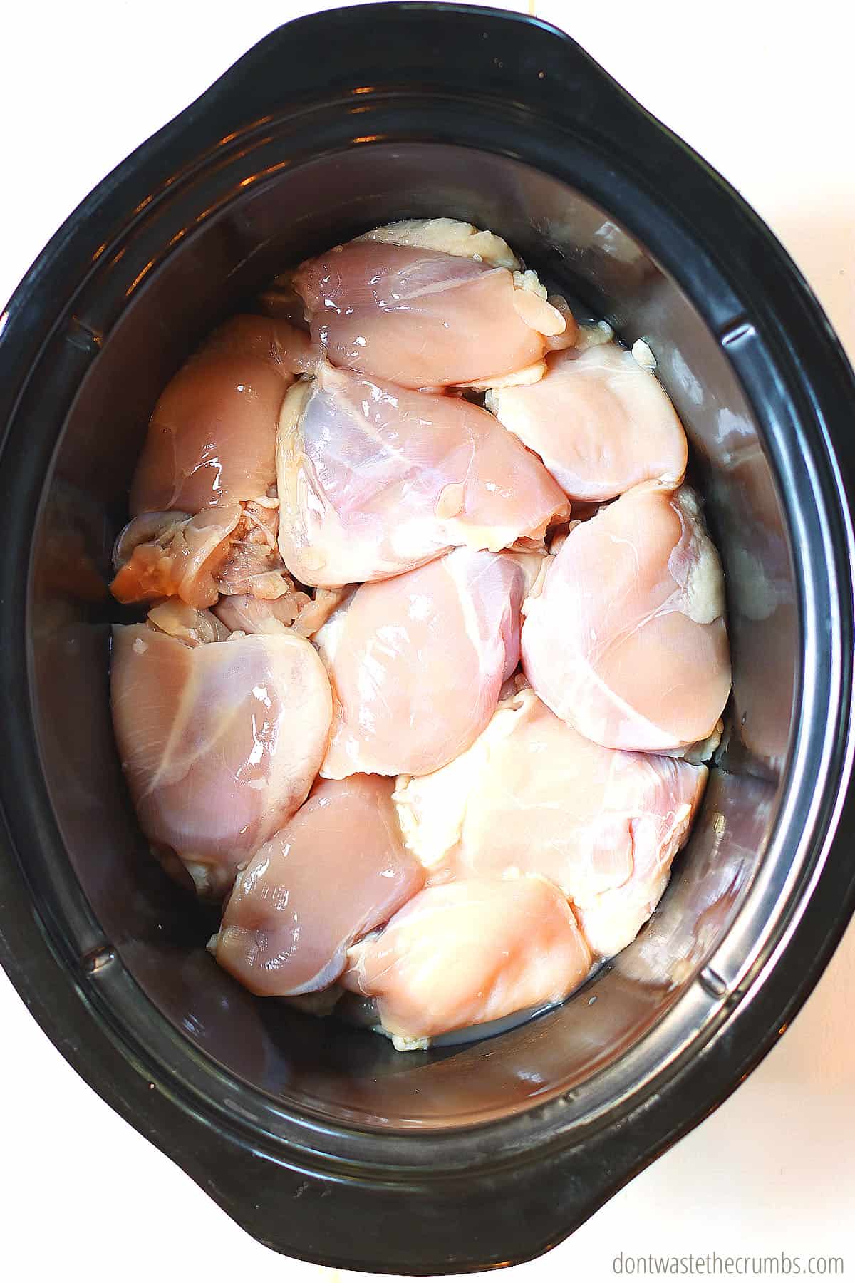 Raw chicken in the slow cooker ready to be made into shawarma.