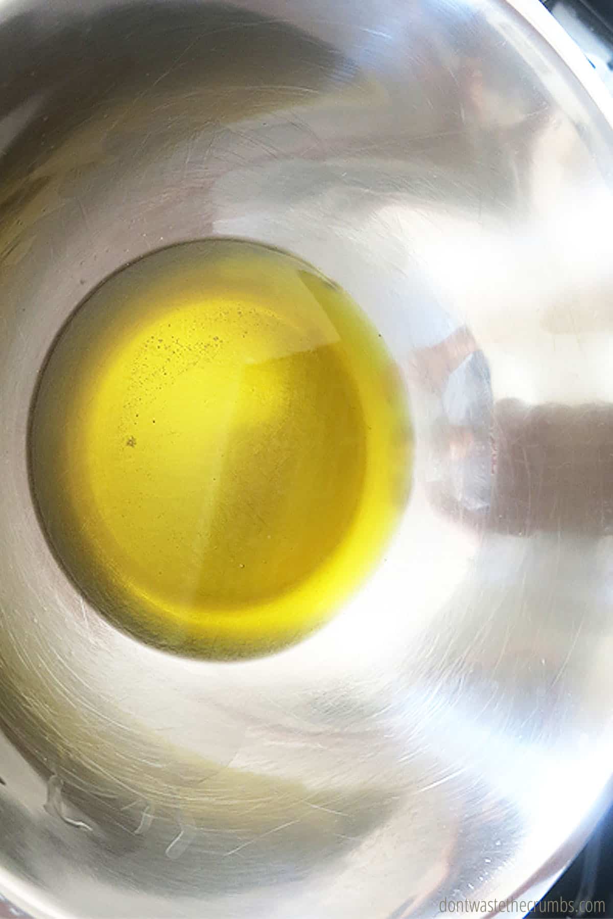 Melted beeswax with comfrey, calendula, cocoa butter and olive oil in a stainless steel double boiler.