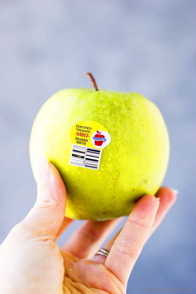 Granny smith apple with an organic PLU sticker.