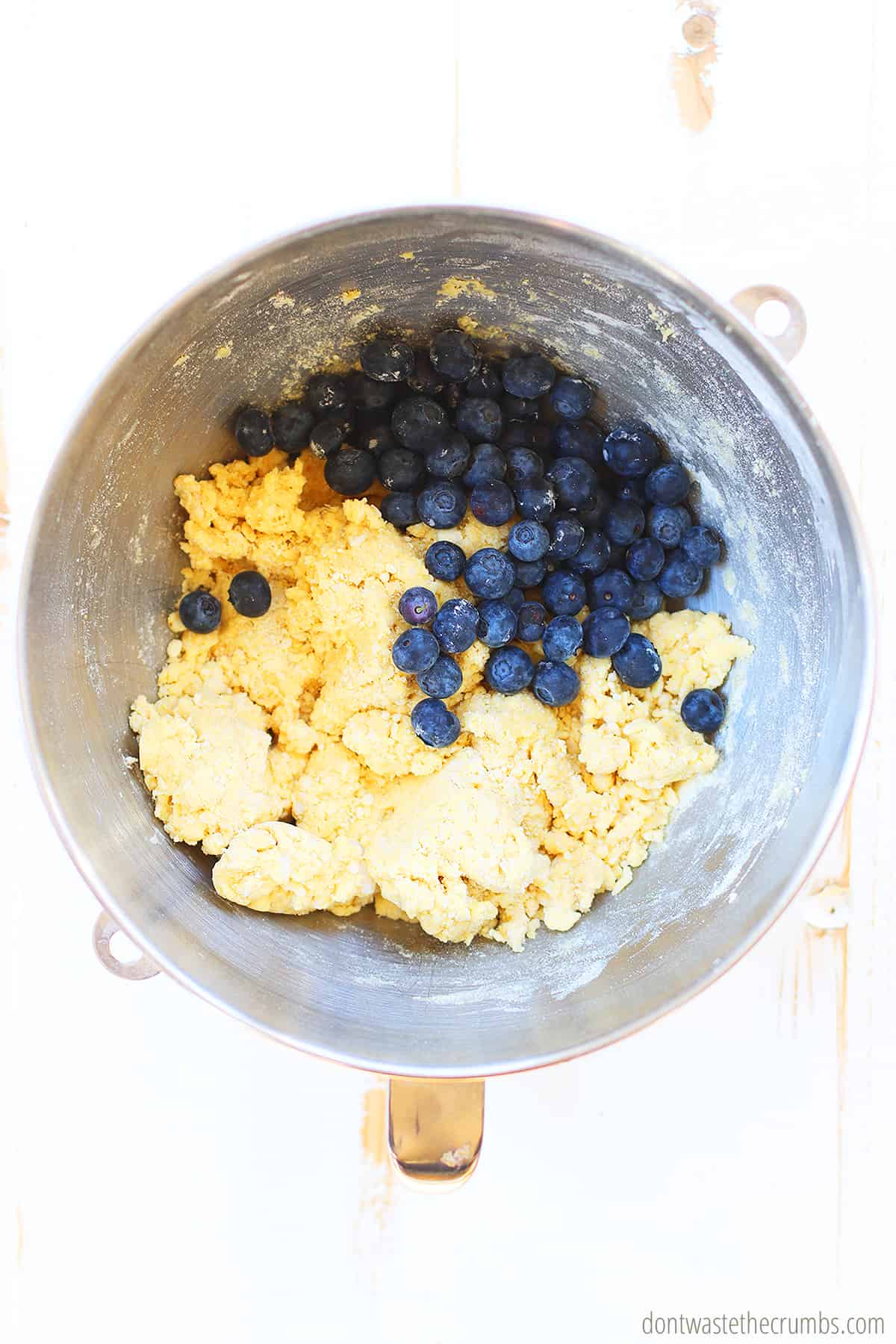 Ingredients for vegan lemon blueberry scones in a mixing bowl.