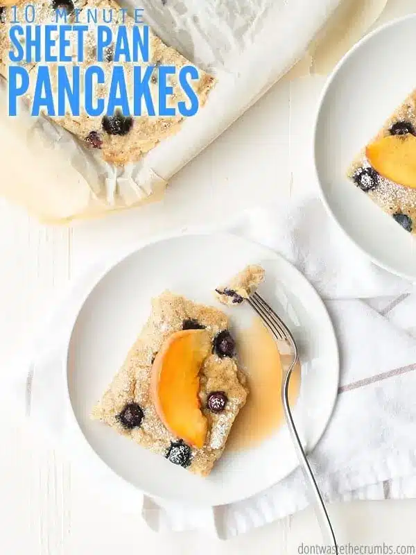 A plate with a slice of the sheet pan pancakes baked with blueberries and topped with peach slices and maple syrup. Text overlay reads "10 Minute Sheet Pan Pancakes".