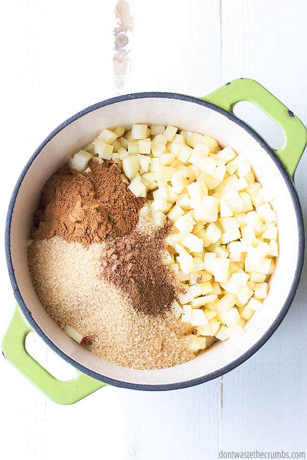 Ingredients that will make homemade apple jam in a large pot.