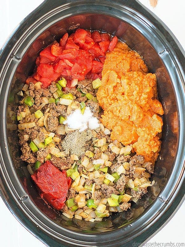 Pumpkin chili ingredients in a slow cooker.