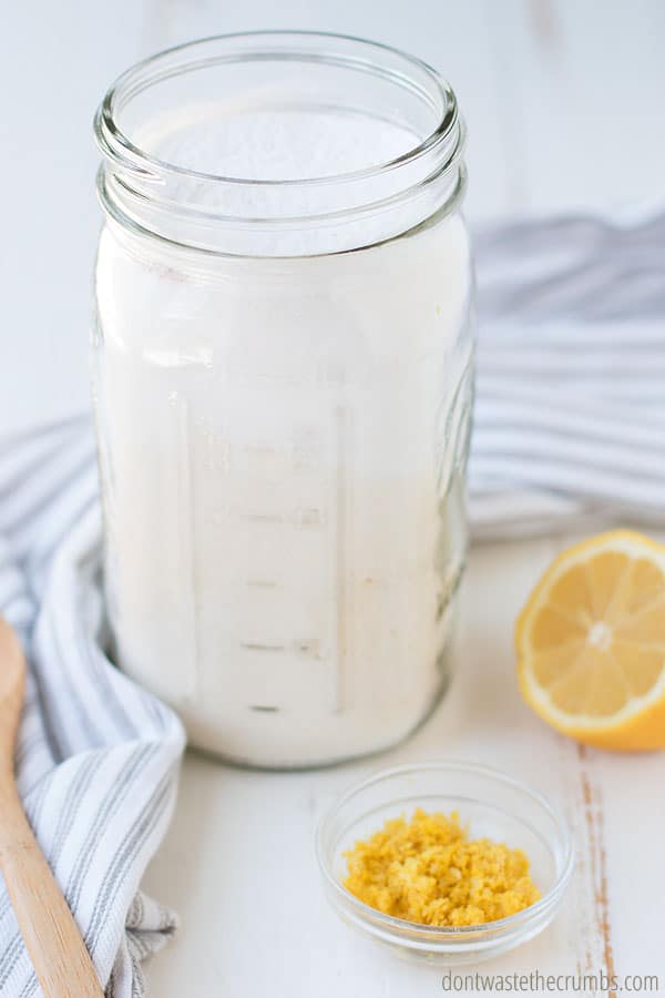 Adding all of the dry ingredients for homemade lemon cake mix into a mason jar is the perfect way to store your fresh cake mix.