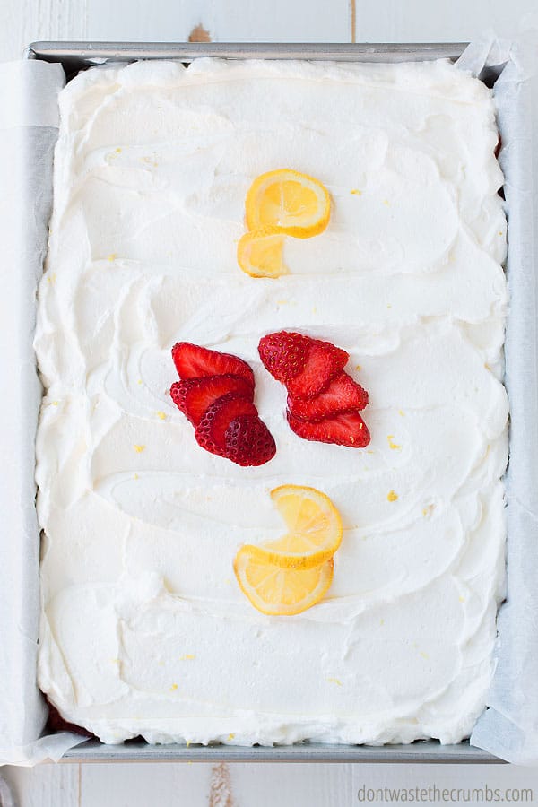 Spread homemade whipped cream topping all over the top of your strawberry poke cake.
