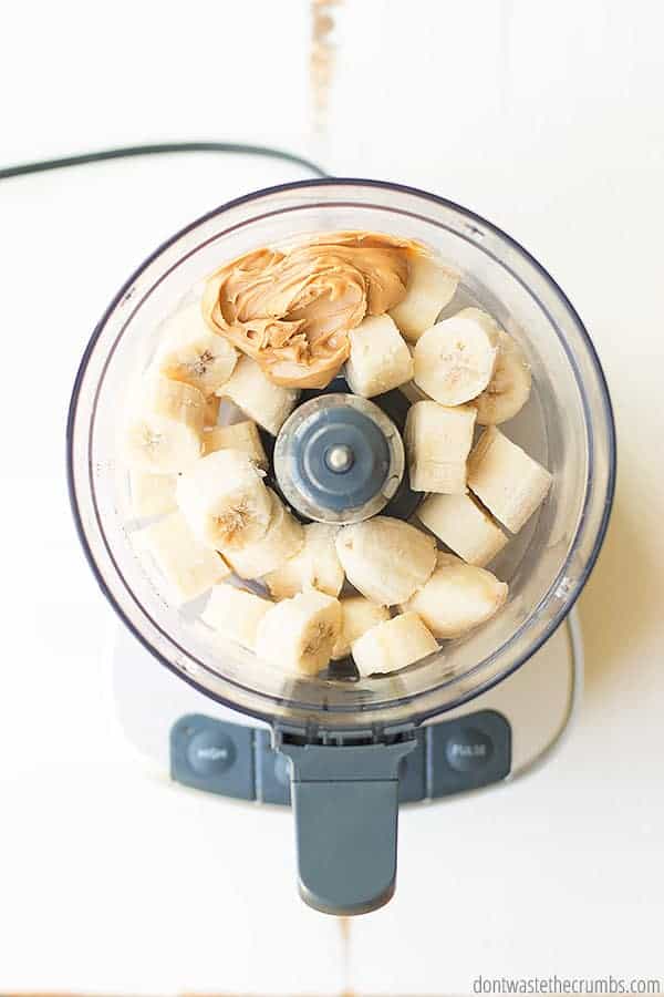 Sliced bananas and peanut butter in a food processor.