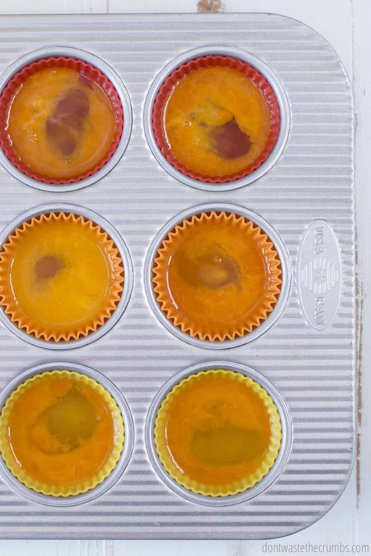 Lightly beaten eggs in a muffin tin ready to be frozen for long term storage. 