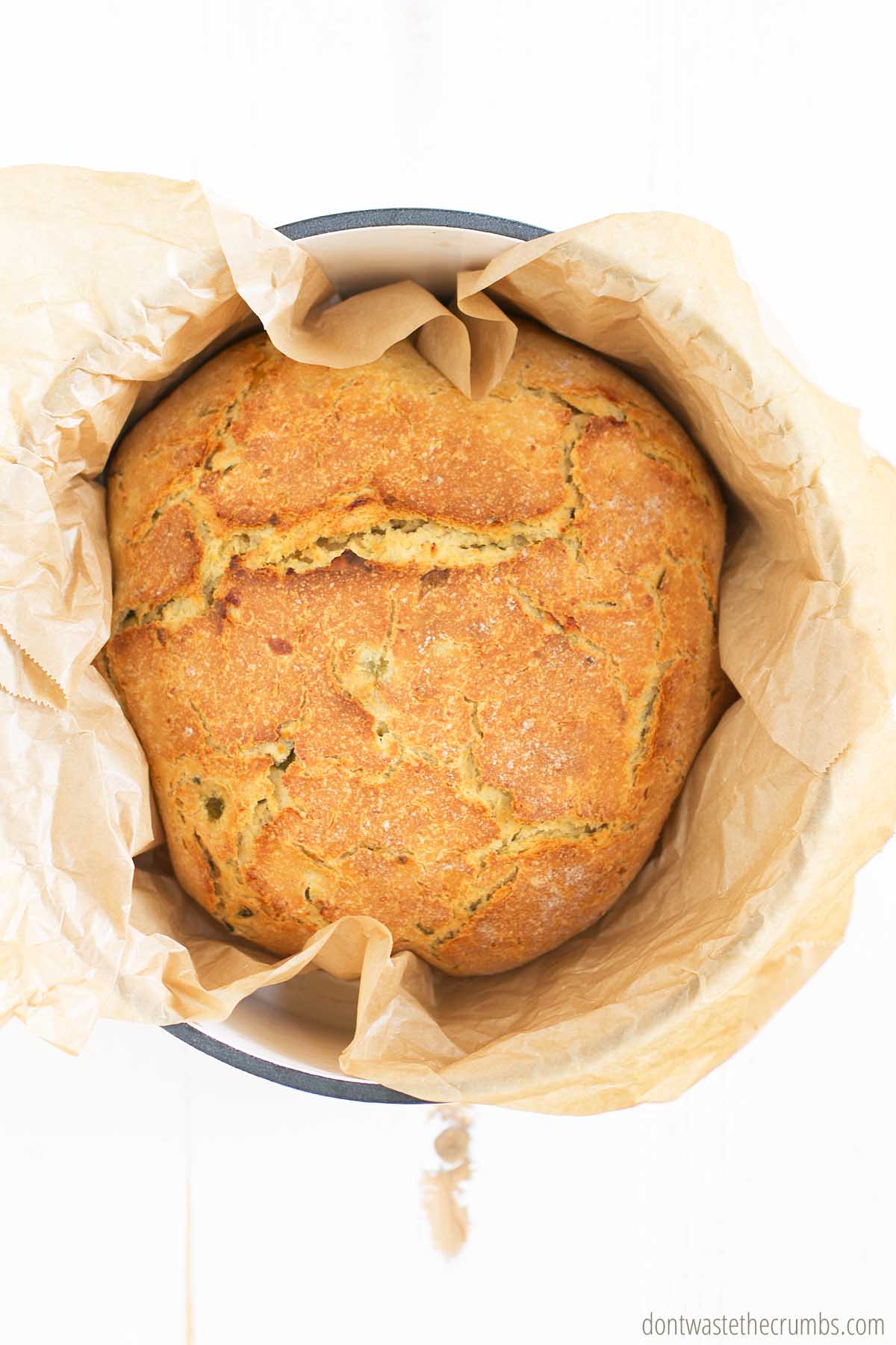 Fully baked jalapeno cheddar bread inside of a Dutch oven.