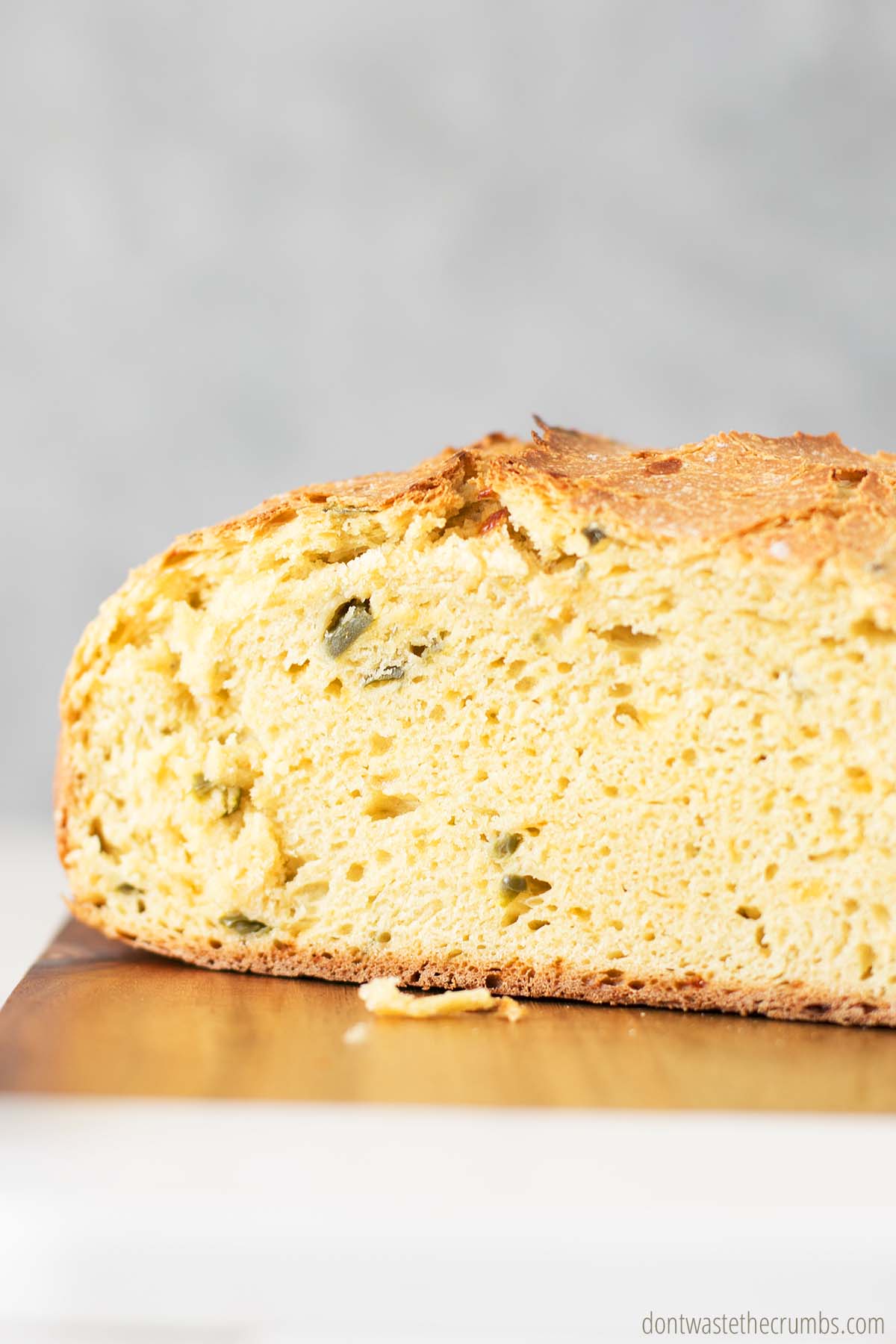 Side image of a sliced loaf of jalapeno cheddar bread.