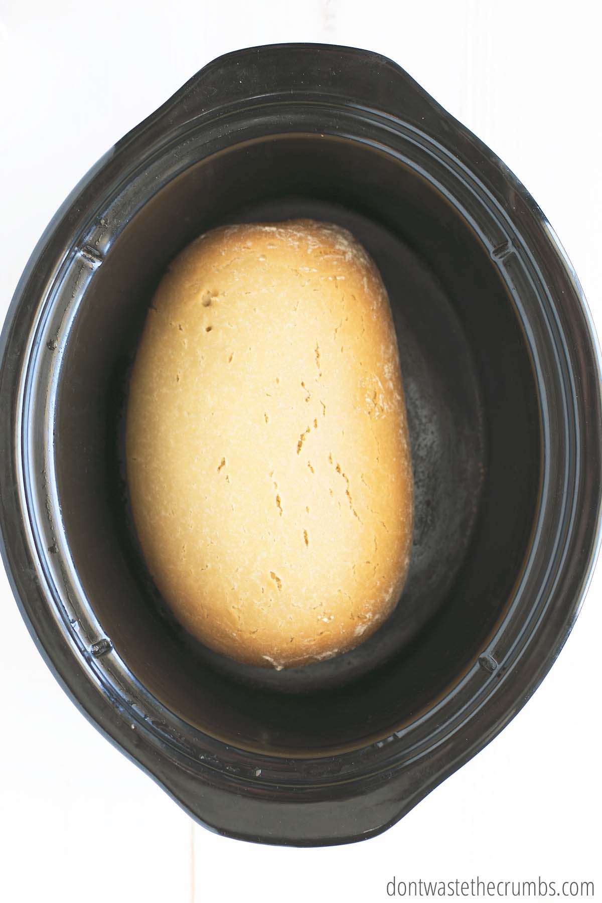 Baked loaf of bread in a slow cooker.