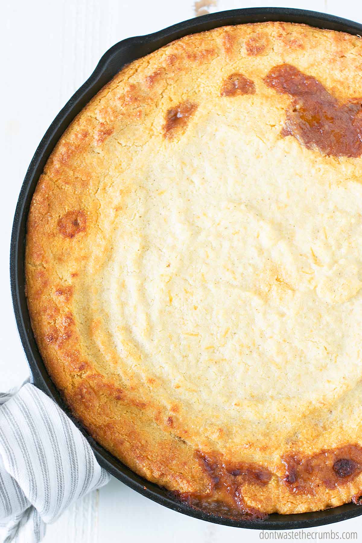 Cooked beef tamale pie in a cast iron skillet
