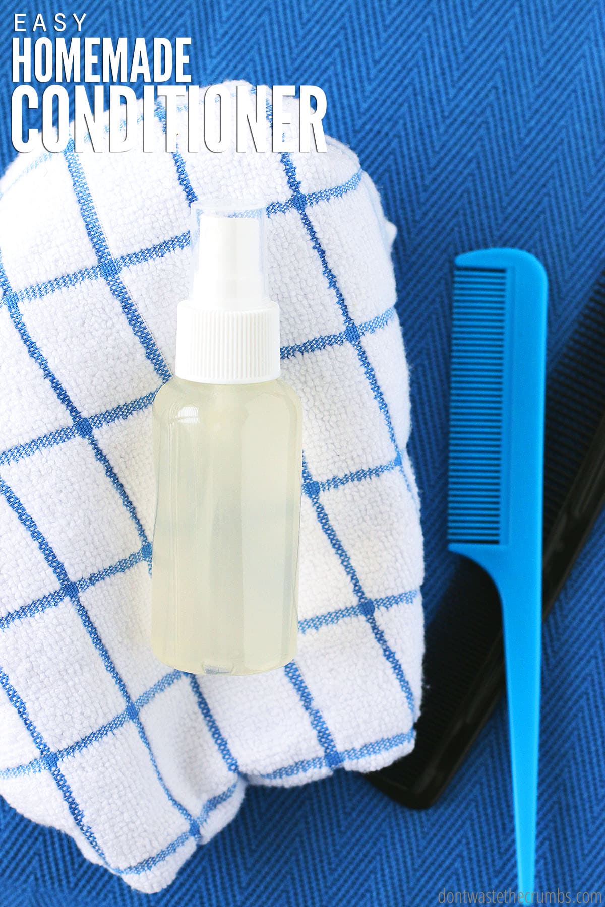 A spray bottle of homemade conditioner lying on a checked towel, with a comb to the right.