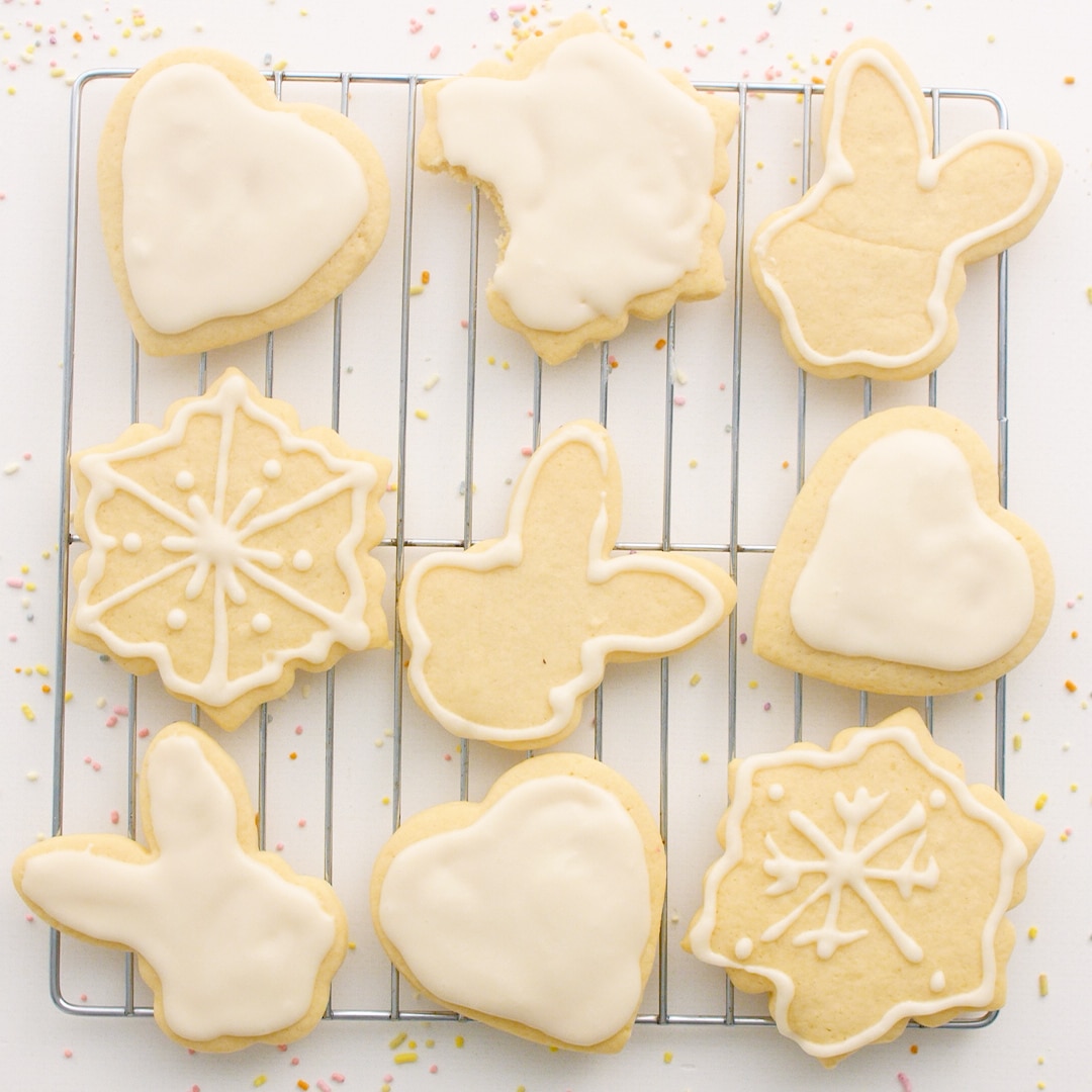 Iced and baked sugar cookies on a cooling rack