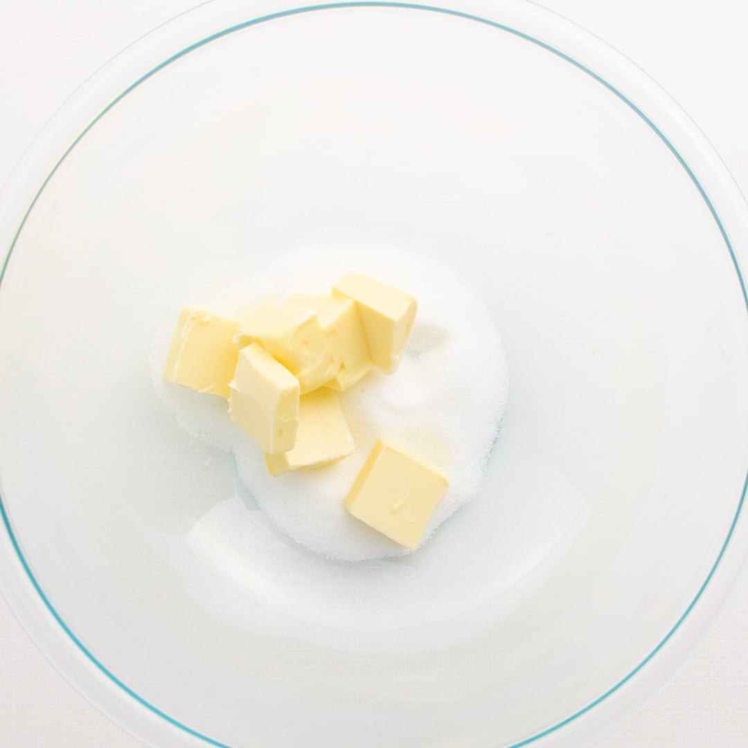 Chopped butter and sugar in a large glass mixing bowl