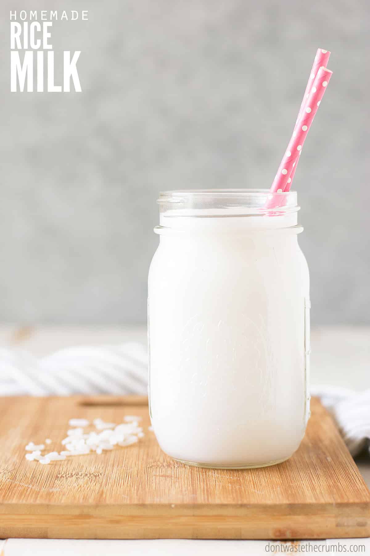 Rice milk in a mason jar with a straw. Text overlay reads: Homemade Rice Milk