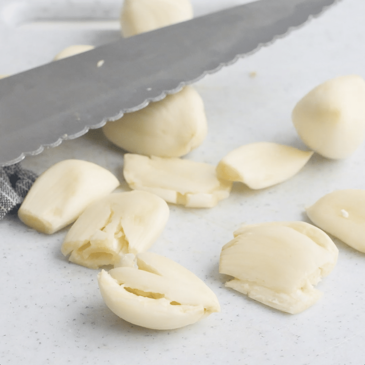 Large knife crushing garlic