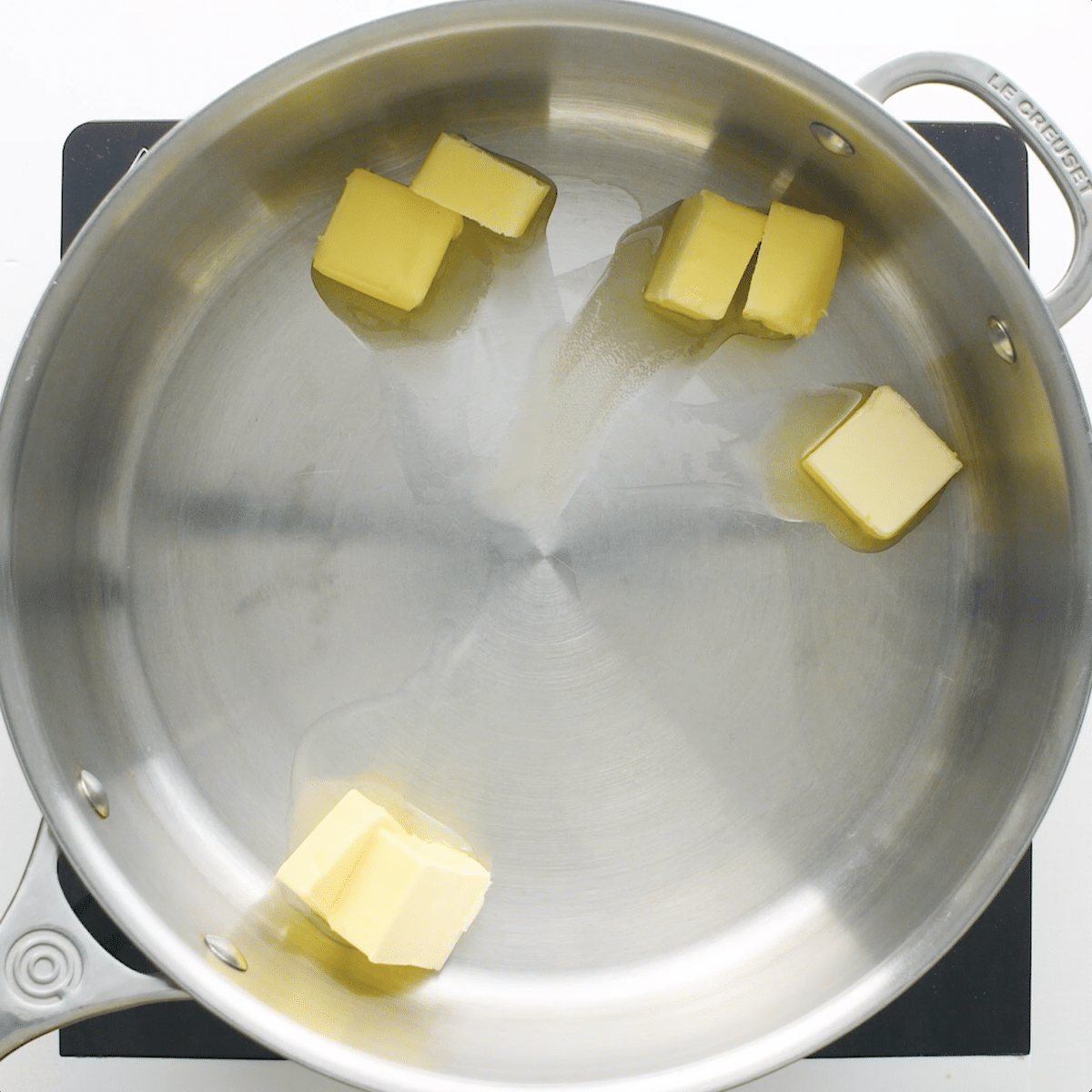Sauce pan with cubes of butter melting
