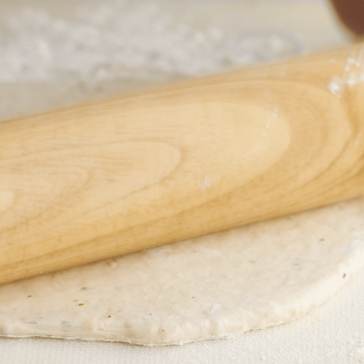 Rolling pin rolling out the cracker dough