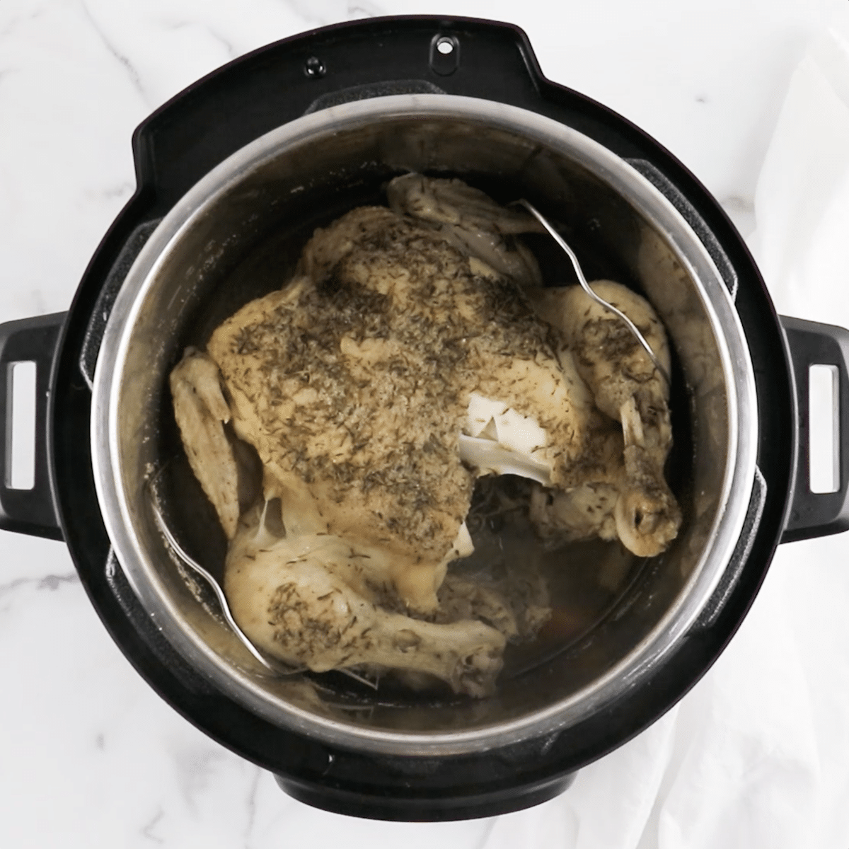 Cooked seasoned whole chicken in an Instant Pot