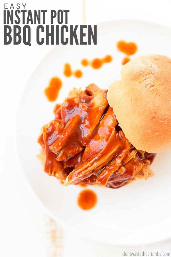 Barbecue chicken slathered in tangy barbecue sauce is topped by a homemade bun. Text overlay reads, "Easy Instant Pot BBQ Chicken".