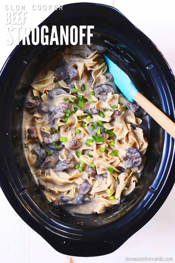 Beef stroganoff in a slow cooker. Text overlay reads, "Slow Cooker Beef Stroganoff".