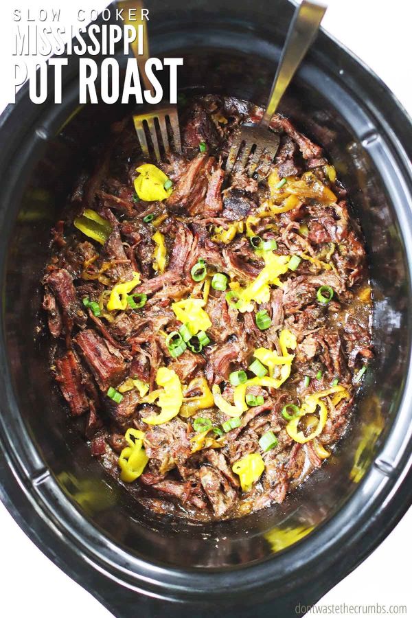 Mississippi pot roast in a slow cooker. Text overlay reads, "Slow Cooker Mississippi Pot Roast".