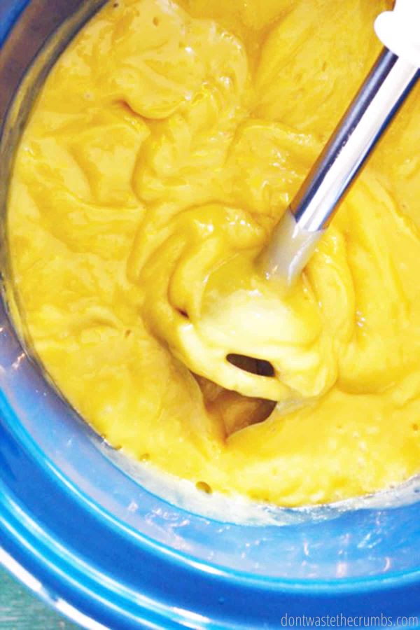 This water/lye and oils mixture is mixed with an immersion blender as it saponifies. It is yellow and the texture of melted cheese.